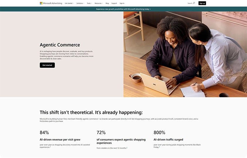 Two people collaborating on a laptop beside Agentic Commerce webpage with AI-driven shopping statistics.
