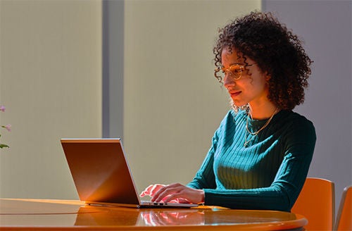 A tablet placed on top of a table displays the wording “Increase brand awareness” along with a “Start” button.