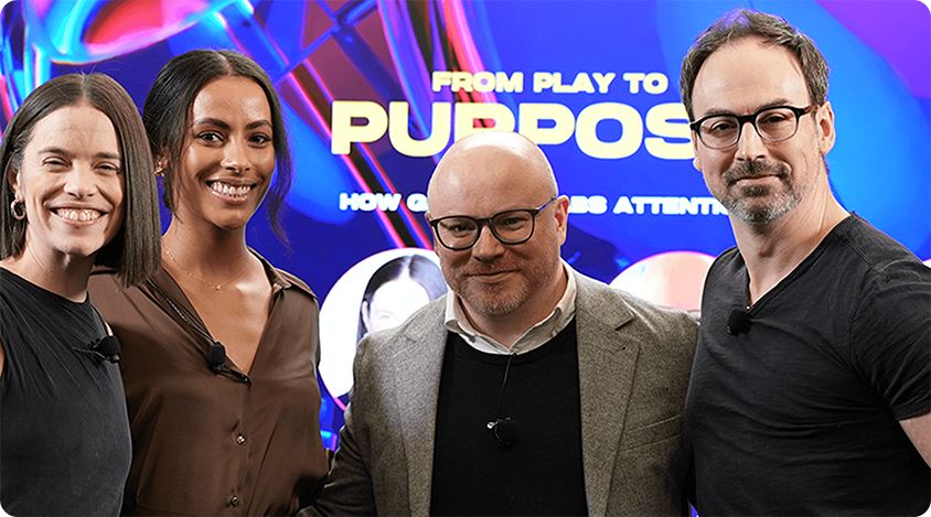 Four people taking a group shot in front of the CES 2025 stage.