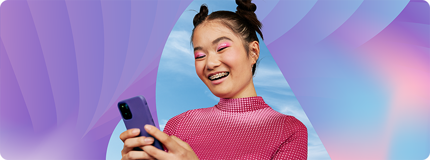 Person wearing a bright pink top holds a smartphone and looks at the screen, set against a colorful abstract background with soft gradients and sky elements, illustrating modern AI-powered marketing and digital discovery.